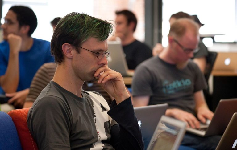 Open Source Maintainers Get a Funding Model That Sticks programmer reviewing code on a monitor